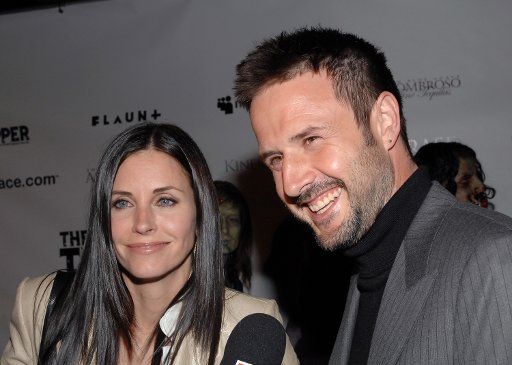 David Arquette (R) who wrote directed and acts in the political satire horror motion picture "The Tripper" and his wife actress Courtney Cox arrive for the film\