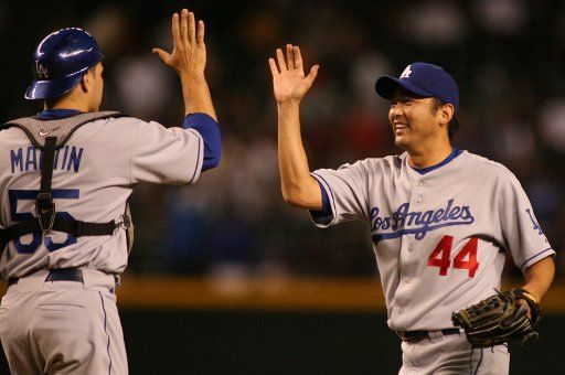 Los Angeles Dodgers pitcher Takashi Saito (44) of Japan gets ready to high five catcher Russell Martin Jr. (55) after Saito and the Dodgers defeated the Arizona Diamondbacks 6-4 at Chase Field in Phoenix  Arizona April 17 2007. (UPI Photo\/Art Foxall)