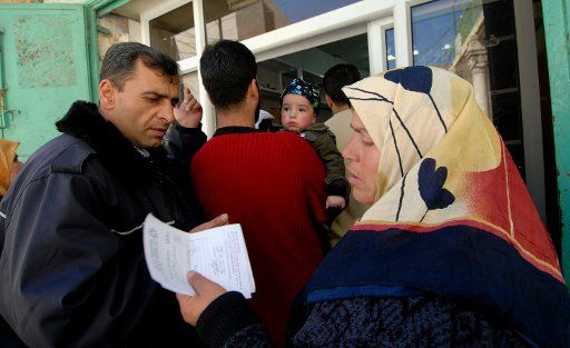 Palestinians wait to receive medicines from a mobile pharmacy set up by Physicians For Human Rights in Hebron West Bank on March 10 2007.  (UPI Photo\/Debbie Hilll)