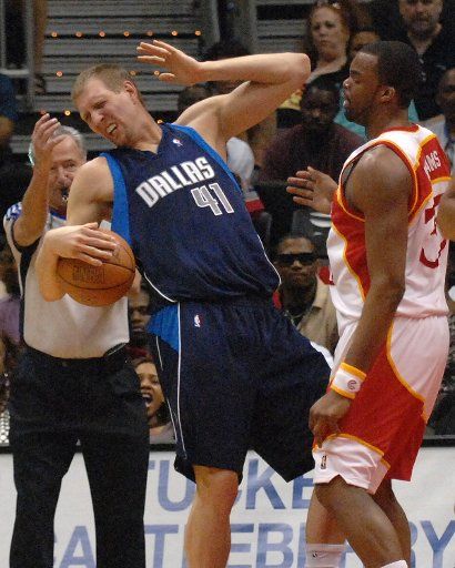 Dallas Mavericks Dirk Nowitzki (left) of Germany reacts to a foul by Atlanta Hawks Shelden Williams in the second period at Philips Arena in Atlanta March 25 2007. The Mavericks defeated the Hawks 104-97. (UPI Photo\/John...