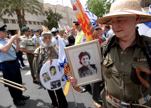 A Jewish World War II veteran from the former Soviet Union holds a photo of herself in uniform to celebrate Victory Day on the 62nd anniversary of the victory of the Allies over Nazi German at a parade in Jerusalem May 9 2007. (UPI Photo\/Debbie ...