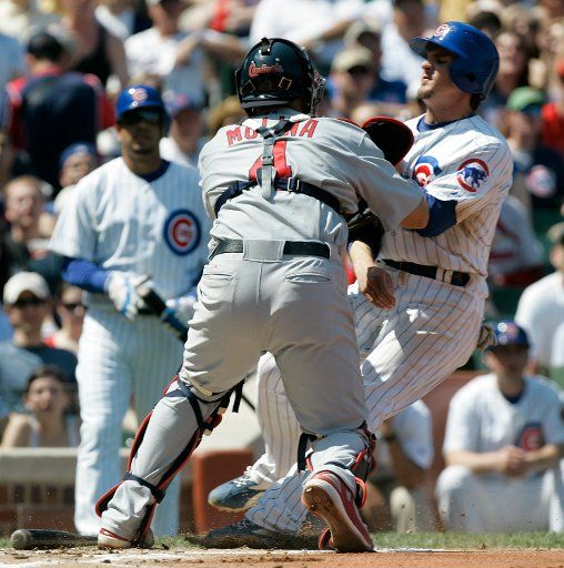 St. Louis Cardinals catcher Yadier Molina (4) tags out Chicago Cubs\