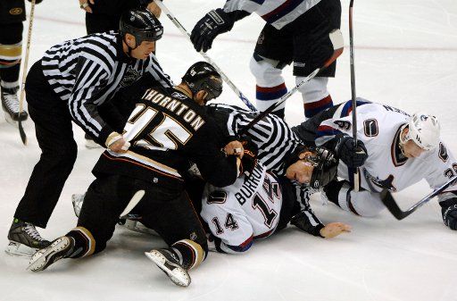 Vancouver Canucks Alex Burrows (C) and Anaheim Ducks Shawn Thornton (L)  fight during the first period of game two of the NHL Western Conference Semifinals April 27 2007 in Anaheim California. (UPI Photo\/Phil McCarten)