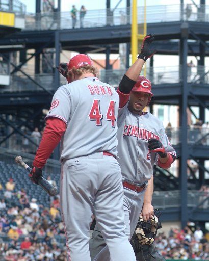Cincinnati Reds  Alex Gonzalez receives a high five following his seventh inning home run in the 9-5 win over the Pittsburgh Pirates from on deck hitter Adam Dunn at PNC Park in Pittsburgh PA on April 29 2007. (UPI Photo\/Archie Carpenter)  