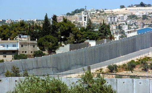 The Israeli separation wall winds around the Aida Refugee Camp in northern Bethlehem West Bank June 27 2007. Palestinian President Mahmoud Abbas ask Israel to remove roadblocks and stop the construction of the separation wall which would ease ...
