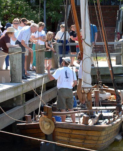 Tourists view a replica of Captain John Smith\