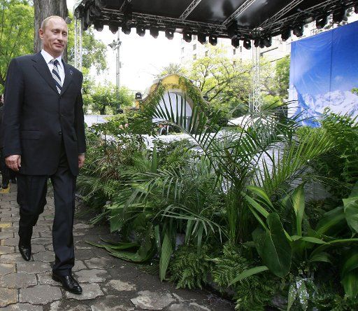 Russian President Vladimir Putin arrives for a presentation to the International Olympic Committee of the country\