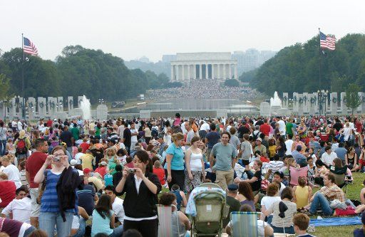 People return to the National Mall and stakeout a spot after an evacuation due to a tornado warning for the annual Independence Day celebration in Washington on July 4 2007. (UPI Photo\/Alexis C. Glenn)