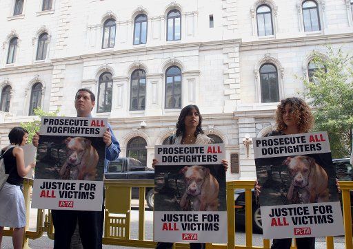 Anti-dog fighting protesters wait for Atlanta Falcons quarterback Michael Vick to arrive at federal court in Richmond Virginia on July 26 2007. Vick is accused of being involved with dog fights on his Virginia property. (UPI Photo\/Roger L. ...