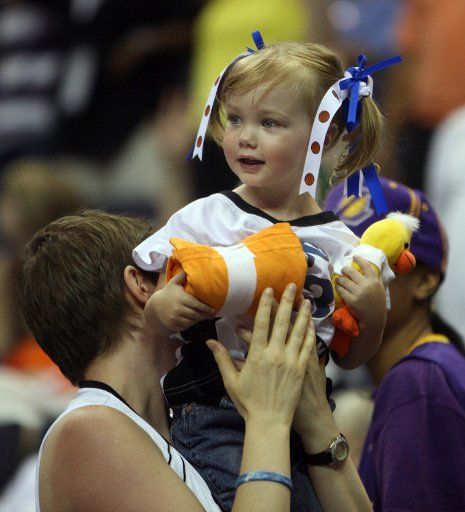 A little fan gets a free t-shirt from cheerleaders at the WNBA All-Star game at Verizon Center in Washington D.C. on July 15 2007. (UPI Photo\/ David Brody)
