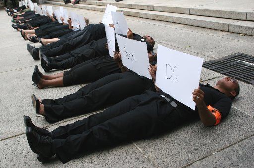 Million Mom March and No Murders DC hold a "lie-in" protest to ask for tighter gun restrictions outside the Barrett Prettyman Federal Courthouse Annex in Washington on July 24 2007. (UPI Photo\/Dominic Bracco II)