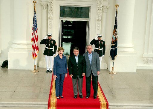 U.S. President George W. Bush (R) and first lady Laura Bush (L) welcome King Abdullah II of Jordan on the North Portico of the White House in Washington on July 24 2007. The King visited the White House for a private dinner. (UPI Photo\/Ron Sachs\/...