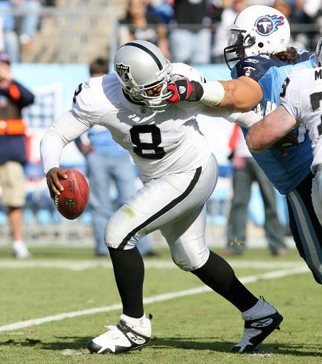 Oakland Raiders quarterback Dante Culpepper (8) is grabbed by the facemask by Tennessee Titans defensive end Travis Laboy (91) at LP Field in Nashville Tennessee on October 28 2007. The Titans defeated the Raiders 13-9. (UPI Photo\/Frederick ...
