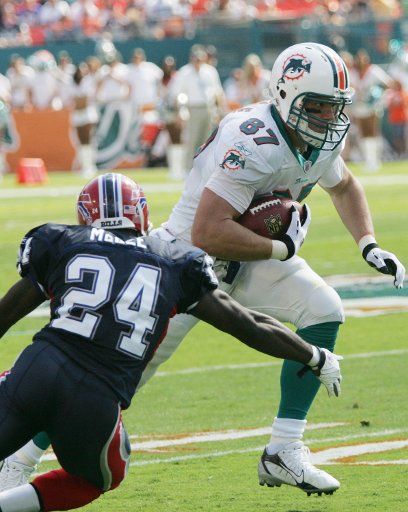 Miami Dolphins Tight End Justin Peelle (87) is tackled by Buffalo Bills Corner back Terrance McGee (24) during first half action at Dolphins Stadium in Miami on November 11 2007. The Buffalo Bills beat the Miami Dolphins 13-10. ...