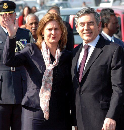 Prime Minister of United Kingdom Gordon Brown and his.wife Sarah wave to the media after arriving in New Delhi India on January 20 2007. Brown arrived in India from China looking for movement from New Delhi on tackling climate change while also ...