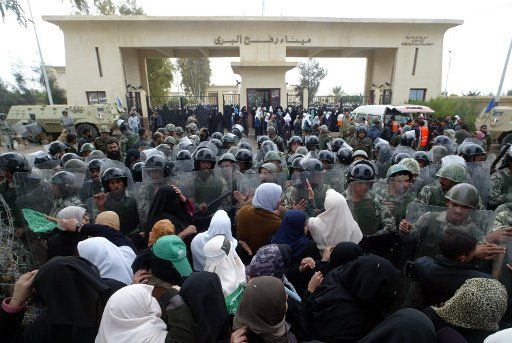 Egyptian security forces contain a crowd of Palestinian women trying to cross into Egypt through the Rafah border crossing in Gaza on January 22 2008. Dozens of Palestinians broke through the border crossing into Egypt during clashes between ...