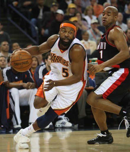Golden State Warriors Baron Davis (5) drives around Portland Trail Blazers Jarrett Jack in the first quarter at the Oracle Arena in Oakland California on March 27 2008. (UPI Photo\/Terry Schmitt)
