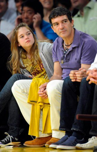 Actor Antonio Banderas and his 11-year-old daughter Stella sit courtside as they attend Game 1 of the Los Angeles Lakers vs.Denver Nuggets NBA Western Conference playoff series at Staples Center in Los Angeles on April 20 2008. The Lakers defeated ...