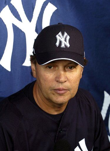 Comedian Billy Crystal sits in the New York Yankees\