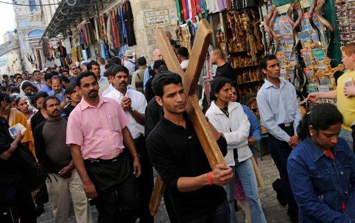 Christians carry a wooden cross along the Via Dolorosa the Way of Sorrows on Good Friday in Jerusalem\