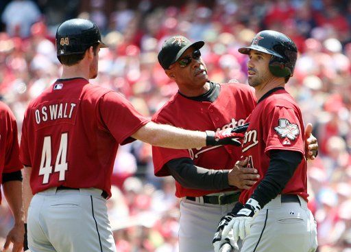 Houston Astros manager Cecil Cooper (C) and pitcher Roy Oswalt (L) restrain batter Brad Ausmus after Ausmus exchanged words with St. Louis Cardinals pitcher Adam Wainwright in the second inning at Busch Stadium in St. Louis on April 26 2008. Aumus ...
