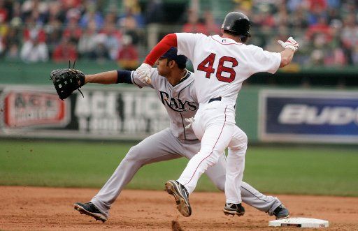 Boston Red Sox base runner Jacoby Ellsbury (46) beats the throw to Tampa Bay Rays first basemen Carlos Pena (L) on a single to Tampa Bay Rays second basemen Akinori Iwamura in the first inning at Fenway Park in Boston Massachusetts on May 4 2008. ...