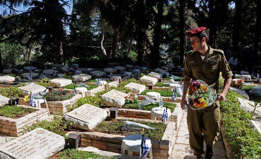 An Israeli soldier carries flowers in the Mt. Herzl Military Cemetery on Memorial Day in Jerusalem May 7 2008. (UPI Photo\/Debbie Hill)