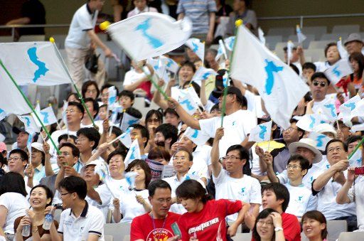 North Korean fans cheer on their team as they play South Korea in the FIFA World Cup Asian qualifiers at the Seoul World cup stadium in Seoul South Korea on June 22 2008. South Korea tied North Korea 0-0. (UPI Photo\/Keizo Mori)