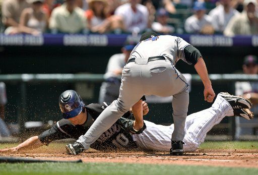 New York Mets starting pitcher Mike Pelfrey tags out Colorado Rockies second baseman Jeff Baker at home plate during the first inning at Coors Field in Denver on June 22 2008. Baker attempted to score from third on a passed ball. (UPI Photo\/Gary ...
