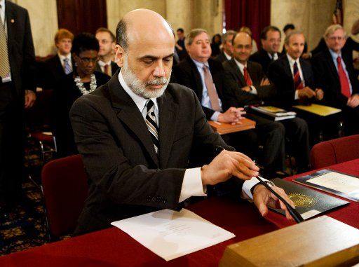 Federal Reserve Board Chairman Ben Bernanke arrives to testify during a Senate Banking Housing and Urban Affairs Committee hearing on the Federal Reserve\