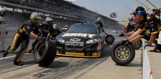 The crew of the US Army Chevrolet driven by Mark Martin (8) scrambles to change all four tires during a pit stop just shy of the halfway point in the 15th annual Allstate 400 at the Brickyard in Indianapolis on July 27 2008. (UPI Photo\/Darrell ...