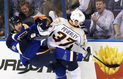 St. Louis Blues Barret Jackman (L) checks Nashville Predators Rich Peverley into the boards during the first period at the Scottrade Center in St. Louis on October 10 2008. (UPI Photo\/Bill Greenblatt)