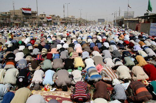 Iraqis in the Shiite enclave of Sadr City show their faith during Friday Prayers in Baghdad on September 5 2008. (UPI Photo\/Ali Jasim)