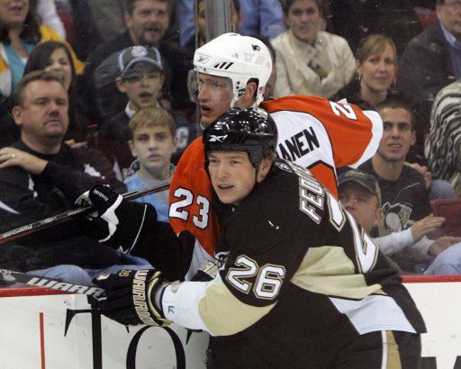 Pittsburgh Penguins Ruslan Fedotenko (26) checks Philadelphia Flyers Ossi Vaananen (23) into the boards during the first period at the Mellon Arena in Pittsburgh on November 13 2008. (UPI Photo\/Stephen Gross)