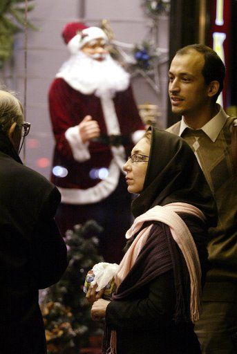 Iranian shoppers in a store decorated for Christmas in uptown of Tehran Iran on December 25 2008. (UPI Photo\/Mohammad Kheirkhah)