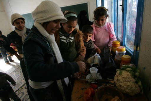 Palestinians take shelter at a United Nations aid center in a school after Israeli air strikes destroyed their homes in Rafah southern Gaza S on January 07 2009.Israeli forces blazed into towns across Gaza yesterday striking Hamas targets and ...