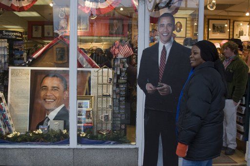 A woman poses for a photo with cardboard Barak Obama in Washington January 18 2009. (UPI Photo\/Kamenko Pajic)