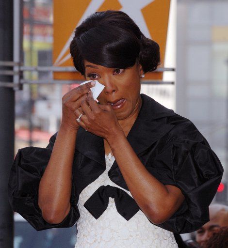 Actress Angela Bassett wipes her eye during an unveiling ceremony honoring her with the 2358th star on the Hollywood Walk of Fame in Los Angeles on March 20 2008. (UPI Photo\/Jim Ruymen)