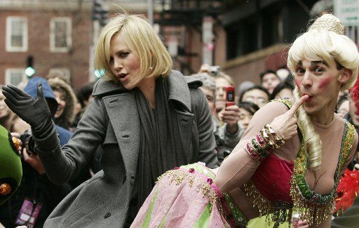 Actress Charlize Theron (L) gives a spanking to Harvard University junior David Andersson during the 2008 Hasty Pudding Theatricals Woman of the Year Parade through Harvard Square in Cambridge Massachusetts on Feburary 7 2008. (UPI Photo\/Matthew ...