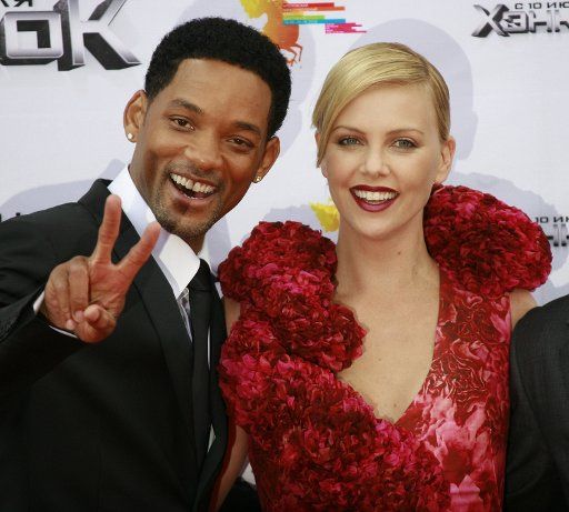 Actor Will Smith (L) and actress Charlize Theron arrive for the opening of the Moscow Film festival where they are promoting their movie \