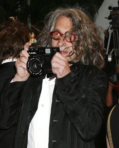 Director Wim Wenders takes a photograph on the red carpet before a screening of the film "The Palermo Shooting" during the 61st Annual Cannes Film Festival in Cannes France on May 24 2008. (UPI Photo\/David Silpa)