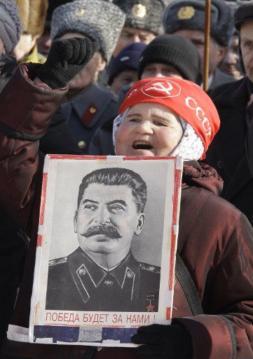 A woman holds a portrait of of Soviet dictator Joseph Stalin during a communist rally to mark Defender of the Fatherland Day in Moscow on February 23 2009. (UPI Photo\/Anatoli Zhdanov)