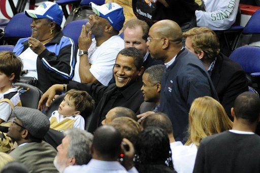 U.S. President Barack Obama (C) attends a NBA (National Basketball Association) game between the Washington Wizards and Chicago Bulls at the Verizon Center in Washington on February 27 2009. (UPI Photo\/Michael Reynolds\/Pool)