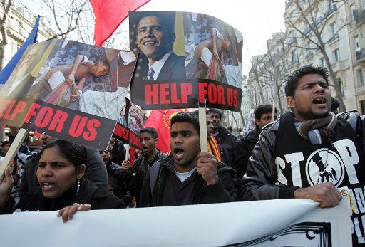 Tamils hold placards during a protest march in Paris February 28 2009. Thousands took to the streets to call on world leaders to help protect Tamil civilians from the Sri Lankan government\
