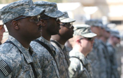 Outgoing U.S. soldiers from the 2-24 Field artillery attend a transfer ceremony in Camp Prosperity in Baghdad on March 4 2009. (UPI Photo\/Ali Jasim)