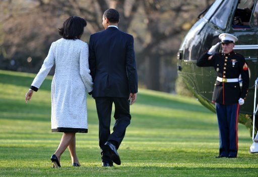 President Barack Obama walks with his wife First Lady Michelle Obama as they depart the White House for a week long trip to Europe in Washington on March 31 2009. This is Obama\