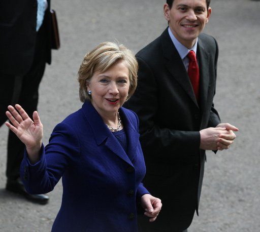 American Secretary of State Hilary Clinton (L) and British Foreign secretry David Milliband (R) wave to the media at No.10 Downing St on the eve of the G20 summit in London on Wednesday April 1 2009. (UPI Photo\/Hugo Philpott)