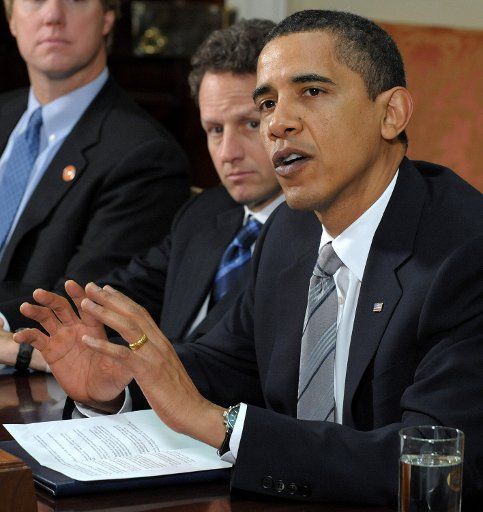 U.S. President Barack Obama speaks to the media after meeting with credit card executives in the Roosevelt Room of the White House in Washington on April 23 2009. At left is Treasury Secretary Timothy Geithner. (UPI Photo\/Roger L. Wollenberg)