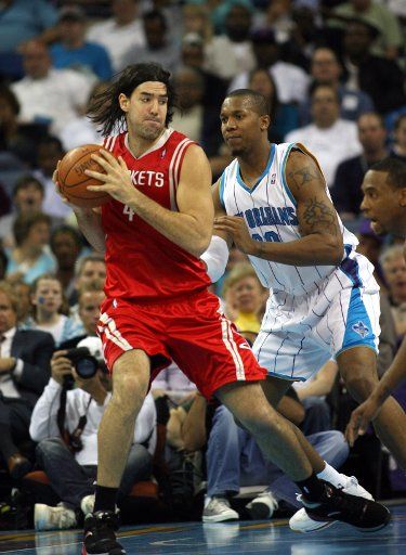 Houston Rockets center Luis Scola (L) works the ball around New Orleans Hornets forward David West during NBA action in New Orleans on March 16 2009. (UPI Photo\/A.J. Sisco)