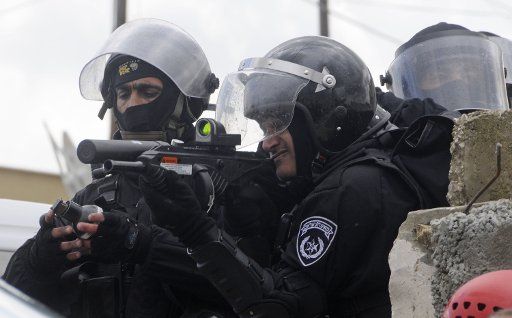 Israeli special police forces fire tear gas during clashes with Israeli Arabs protesting a march by Israeli far-rightists near the Israeli Arab town of Umm al-Fahm March 24 2009. The Jewish far-rightists marchers received approval from the High ...